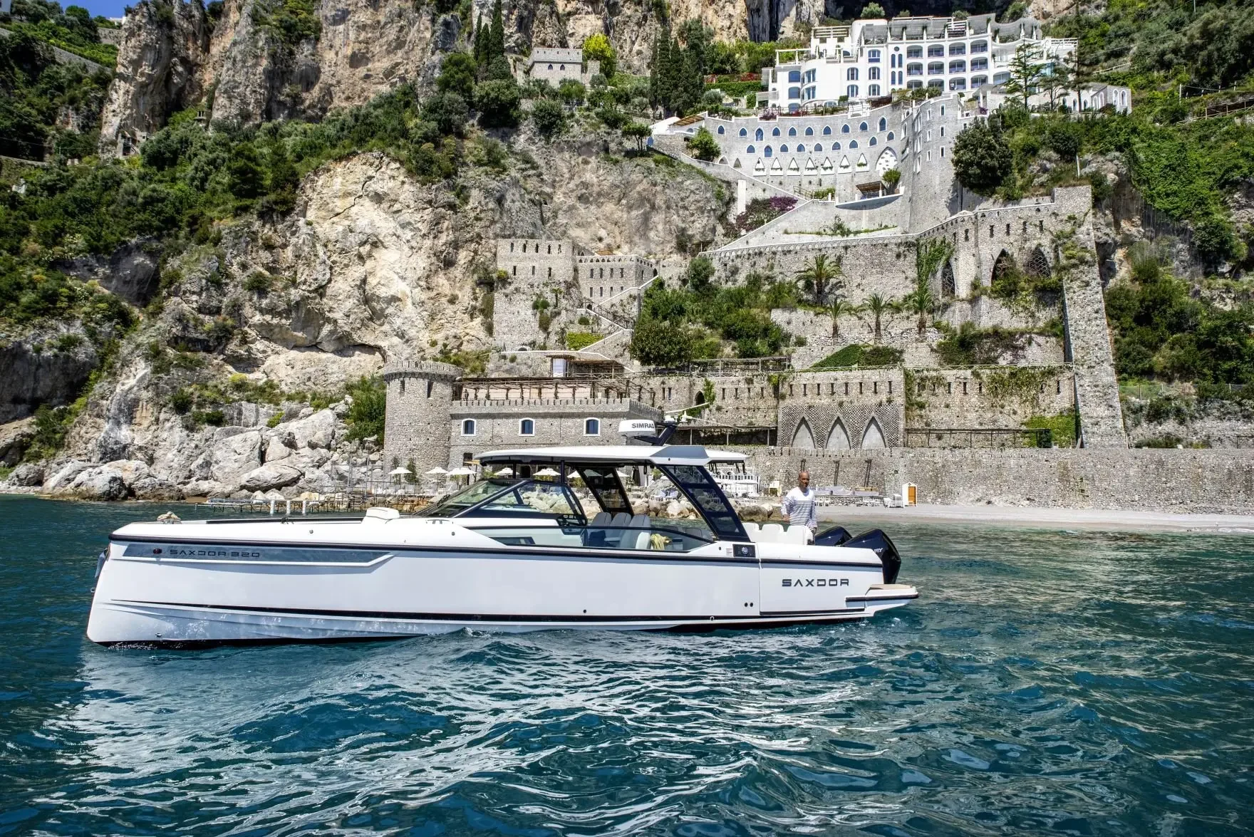 A boat passes the terraced coastline of southern Italy