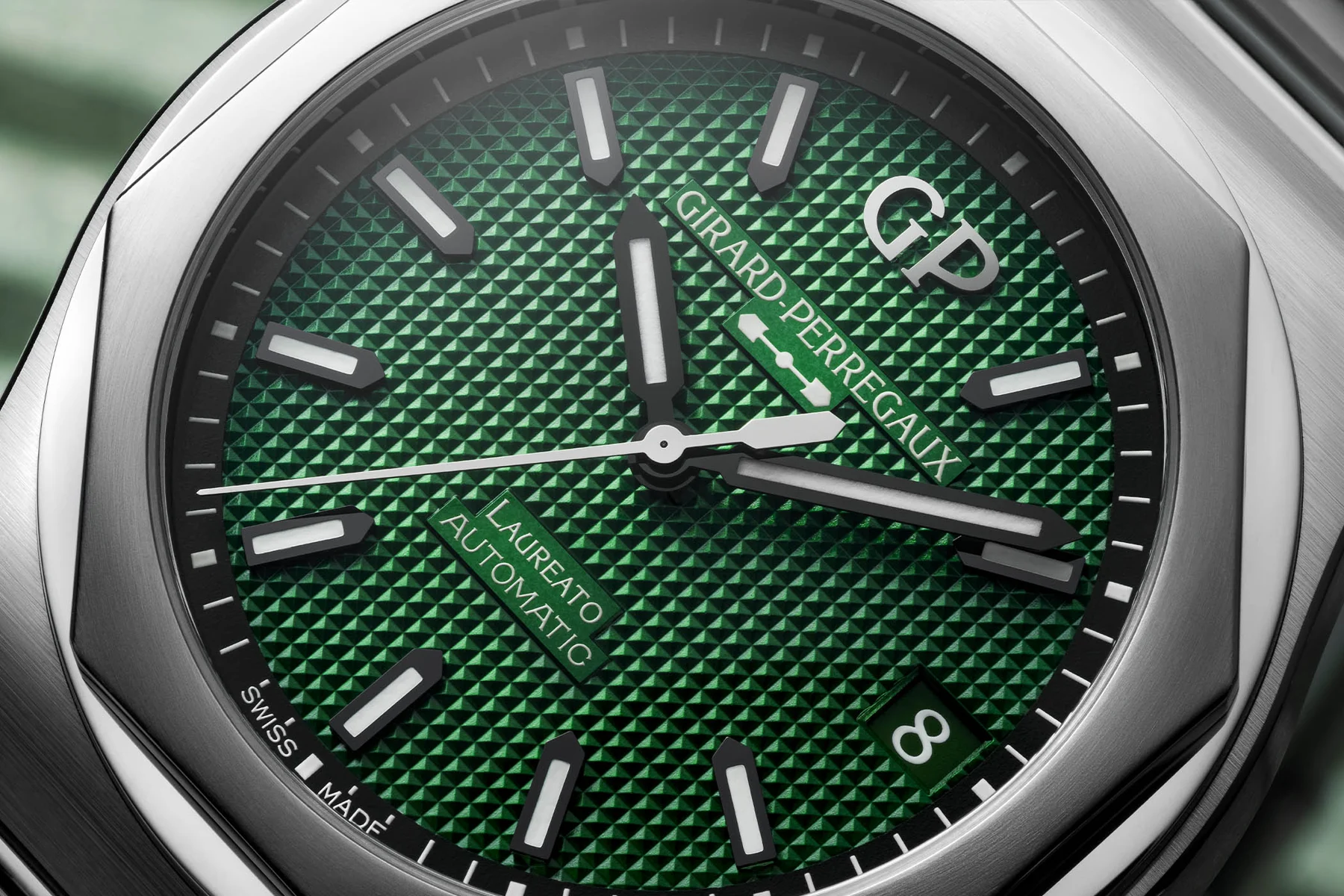 The intricate details of a green-dial mechanical watch